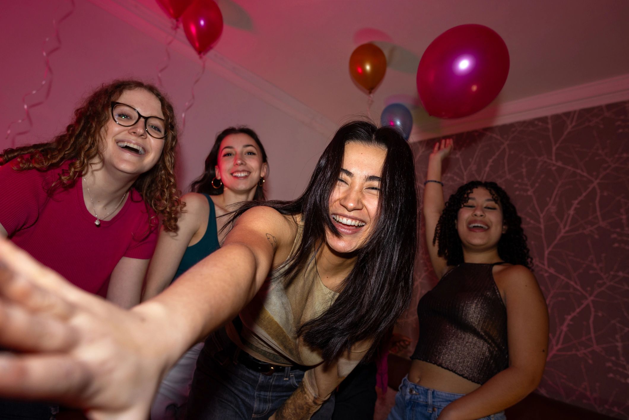 Concert crowd with hands up in the air under lights