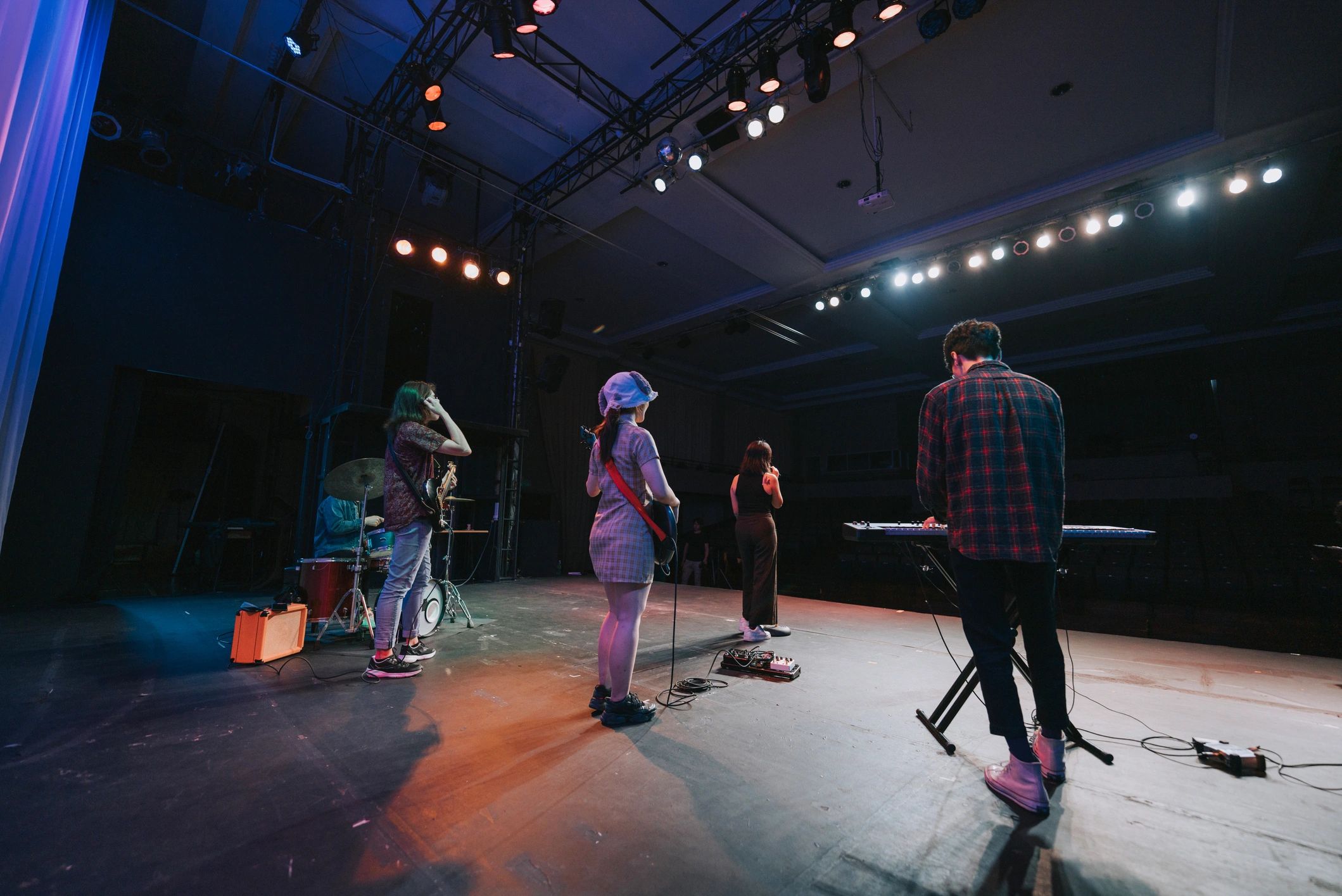 Rock band performing live on stage under concert lights