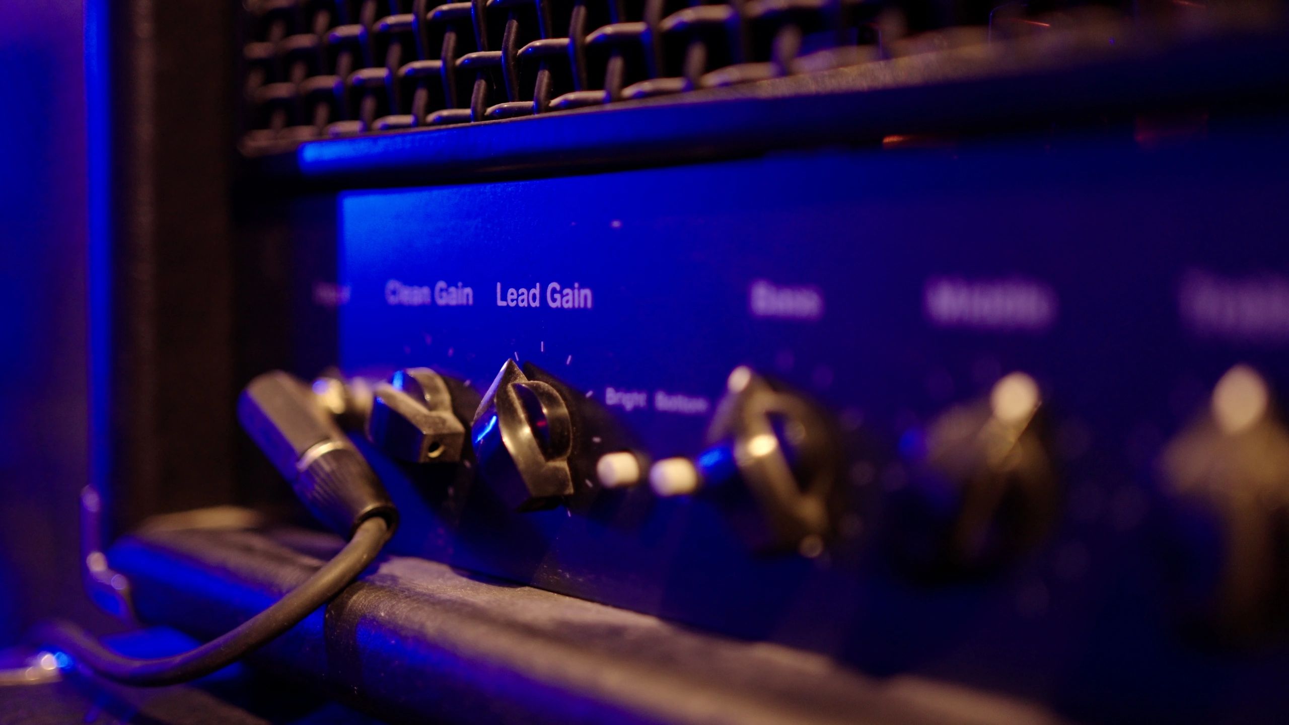 Music amplifier front panel lit by neon lights